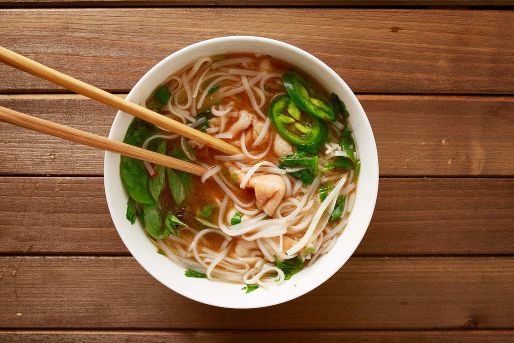 asian bone broth soup recipe in a bowl with chopsticks