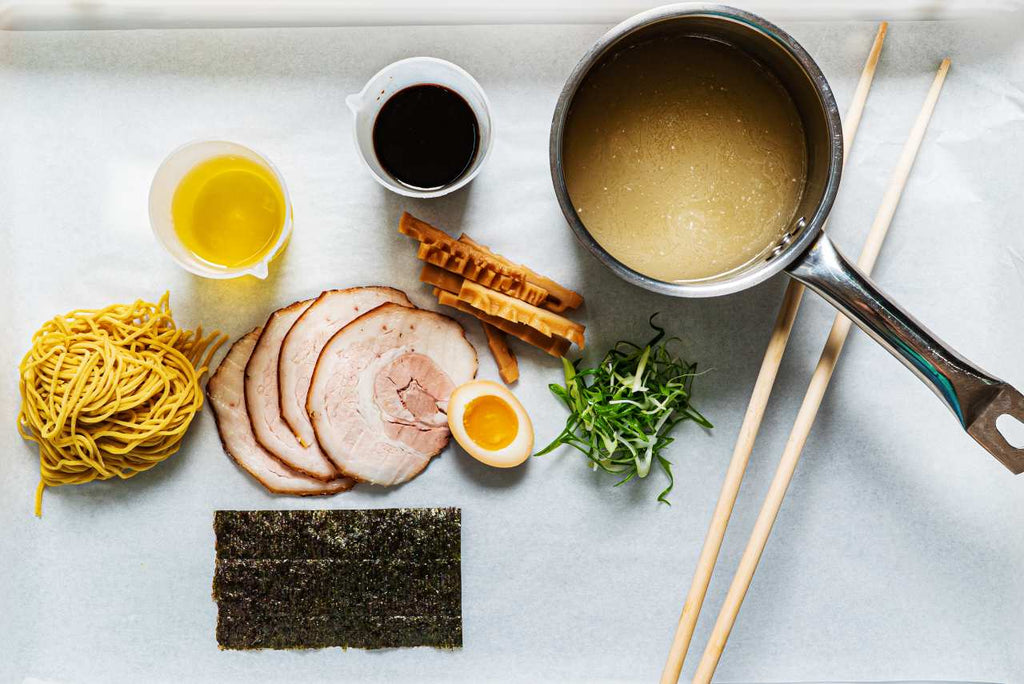 ramen broth ingredients with a pan and chopsticks