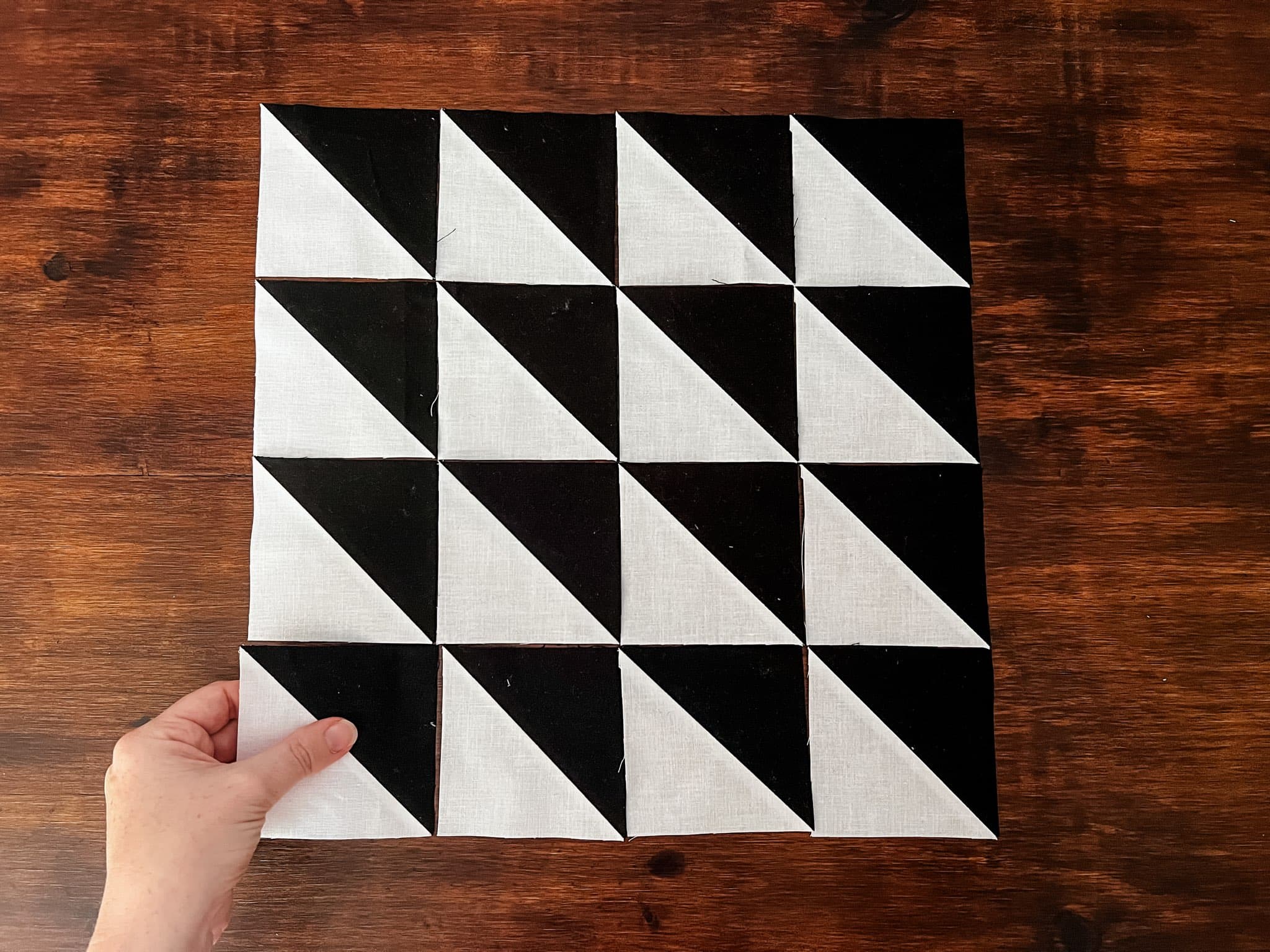 Black and White HSTs being arranged into a quilt block