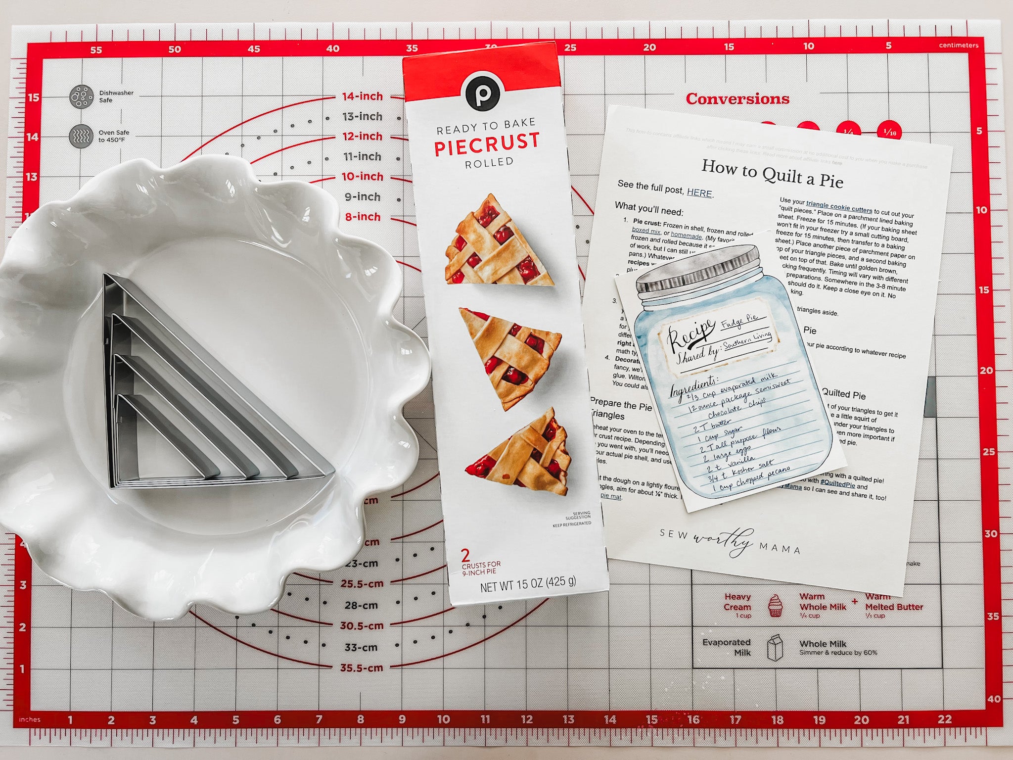 supplies for how to quilt a pie: silicone pastry mat, pie pan, triangle cookie cutters, rolled pie dough, pie recipe, and printable how to guide from sew worthy mama