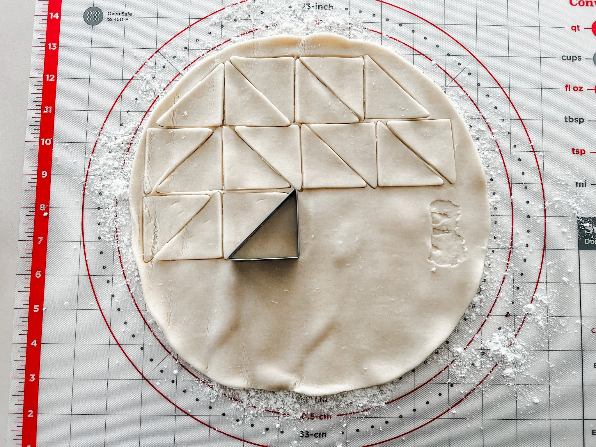 pie dough with triangle cookie cutter, cutting quilt pieces to make a quilted pie