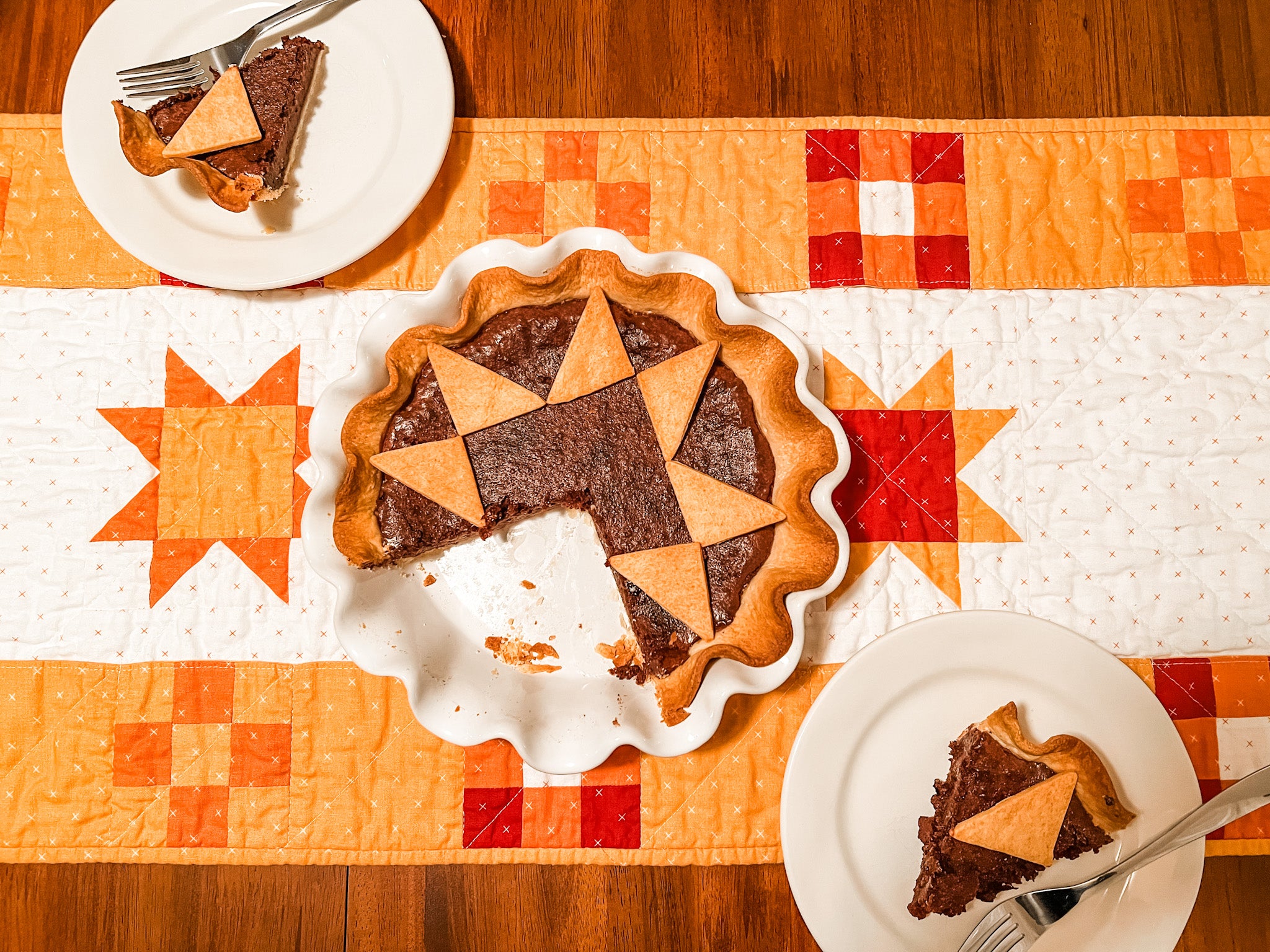 quilted pie on top of pockets full of blessings quilted table runner with 2 pieces of pie served