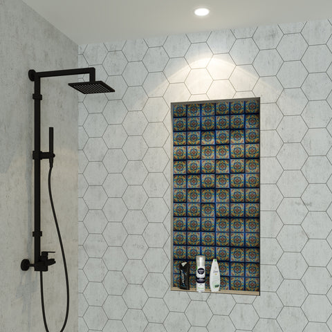 A built-in shelf in the shower backed with patterned tiles