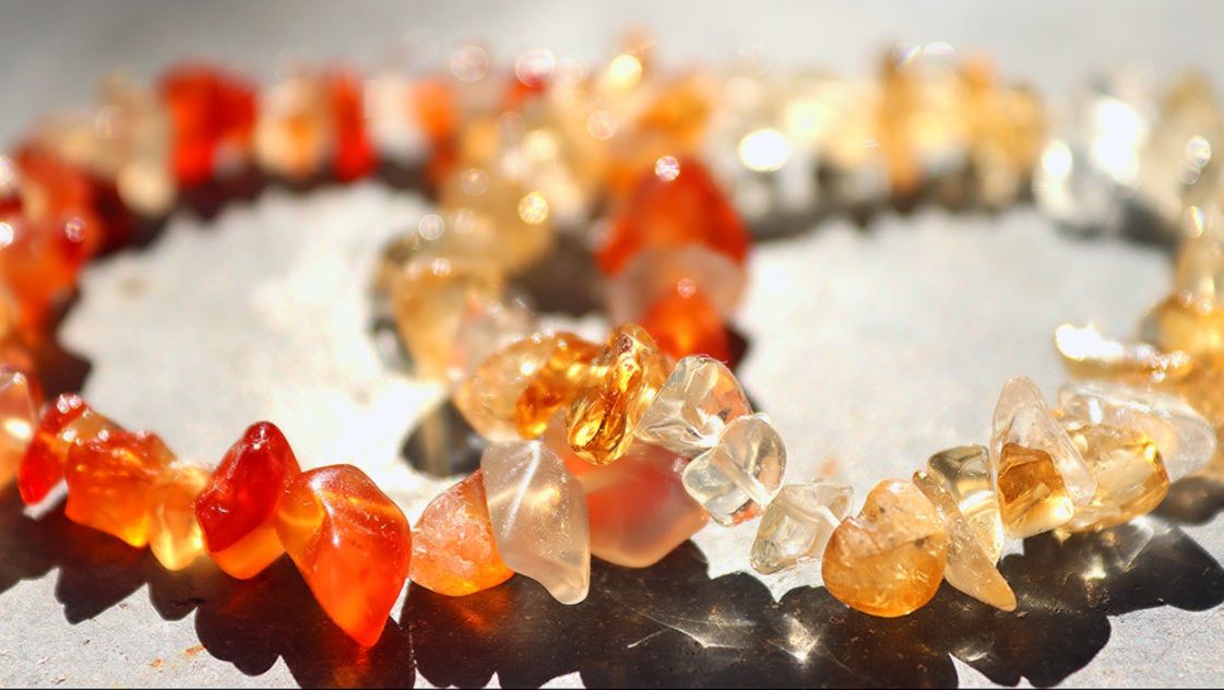 Red and orange crystal bracelets with white gemstones