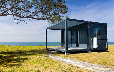 black tiny home cabin in australia on coast looking over sea