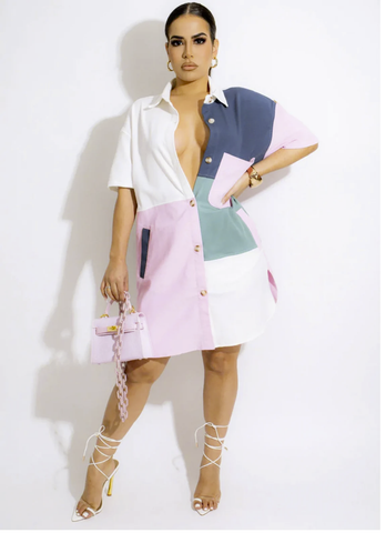 A model poses in a stylish color blocked dress in pastels.