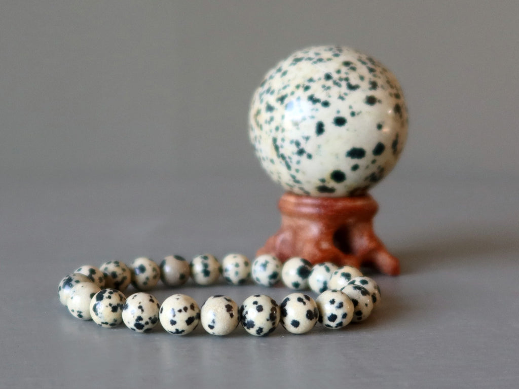 dalmatian jasper bracelet and ball on wood stand