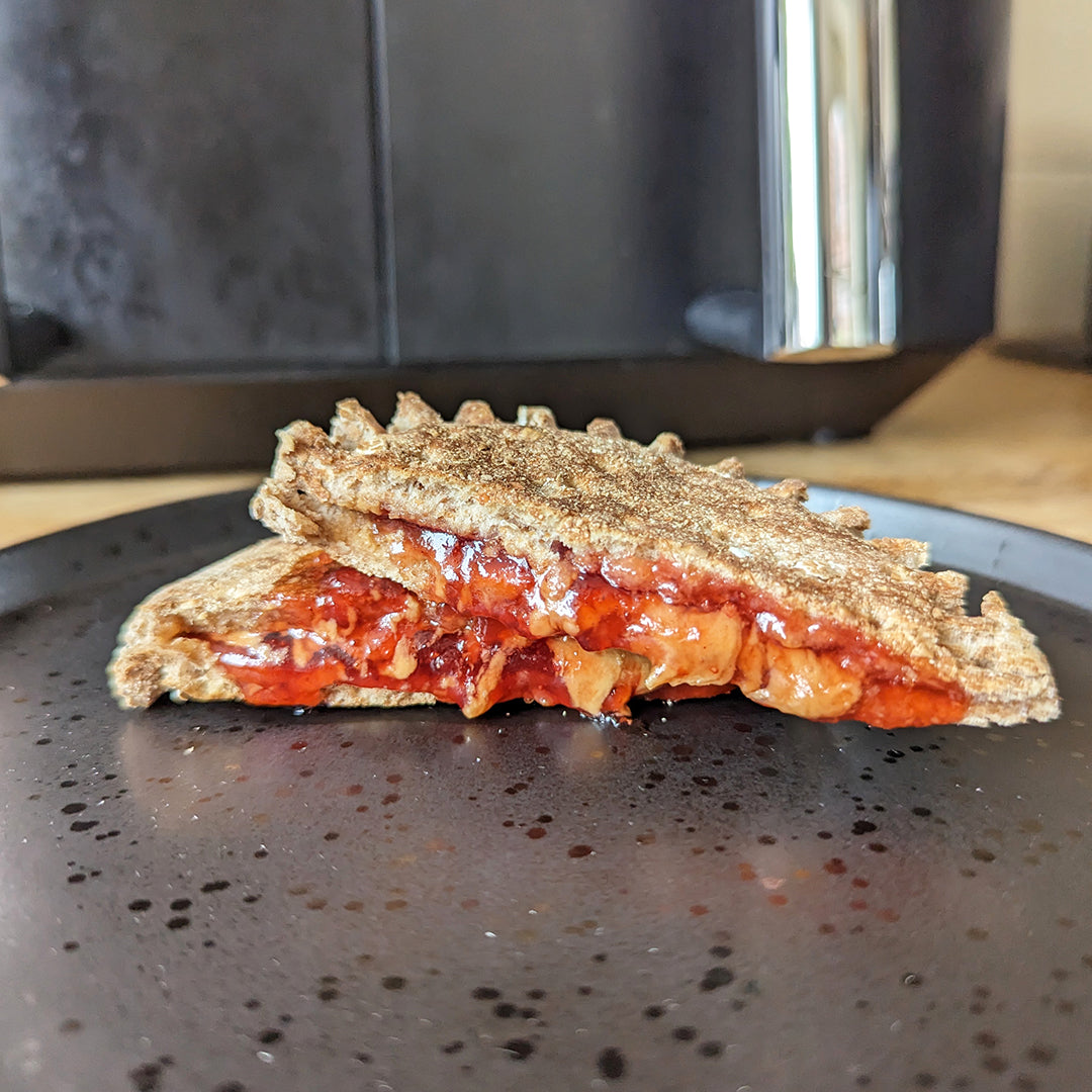A toasted snack filled with jam and peanut butter