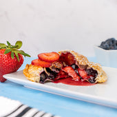 A toasted snack filled with strawberries and blueberries