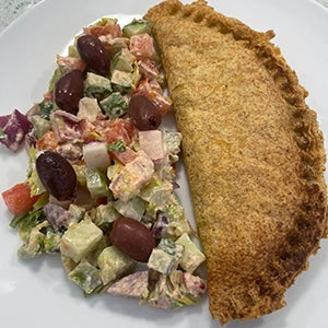 A cooked tortilla served with salad