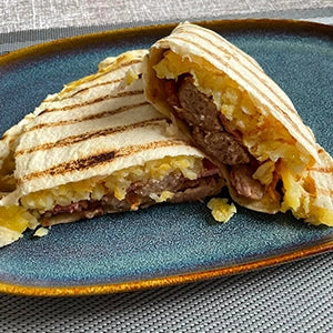 A tortilla filled with sausage, egg and cheese