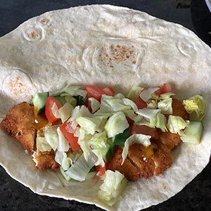 A tortilla with crispy chicken and salad