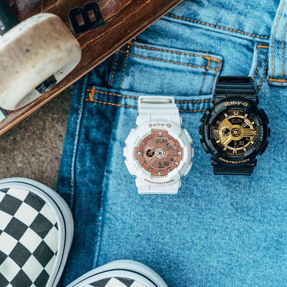 11 Best World Time Watches for Travellers in 2022. Baby G watch resting on jeans next to black skateboard.