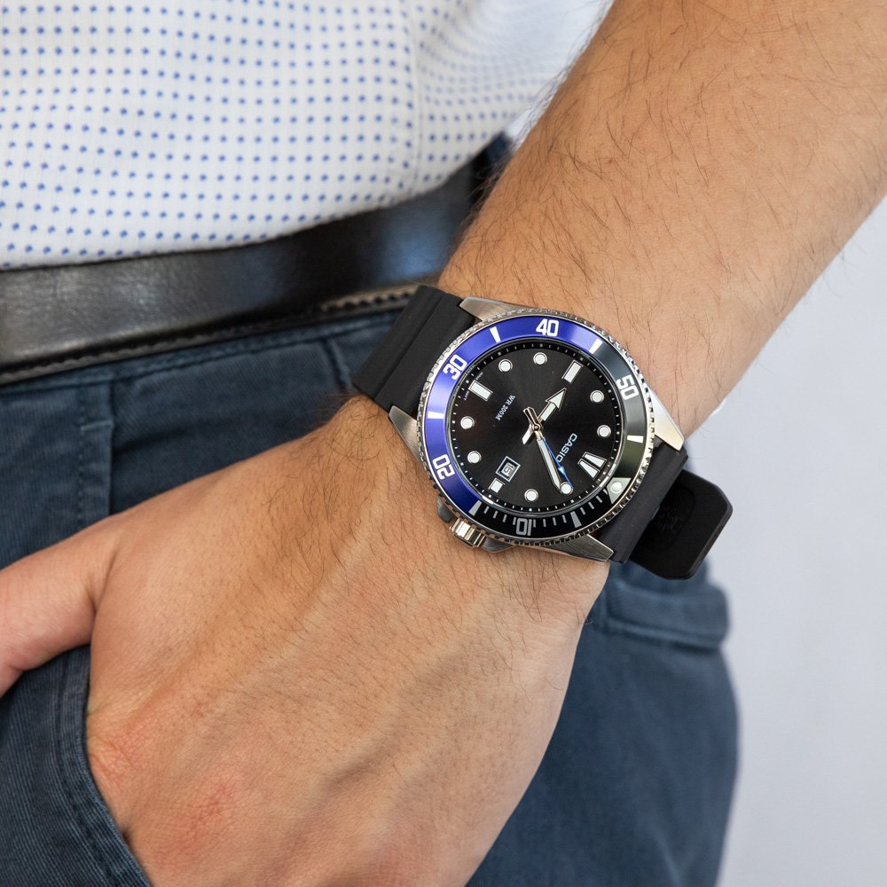 10 Best Dive Watches - Complete Guide For 2022. Casio Duro with half blue, half black bezel on wrist.