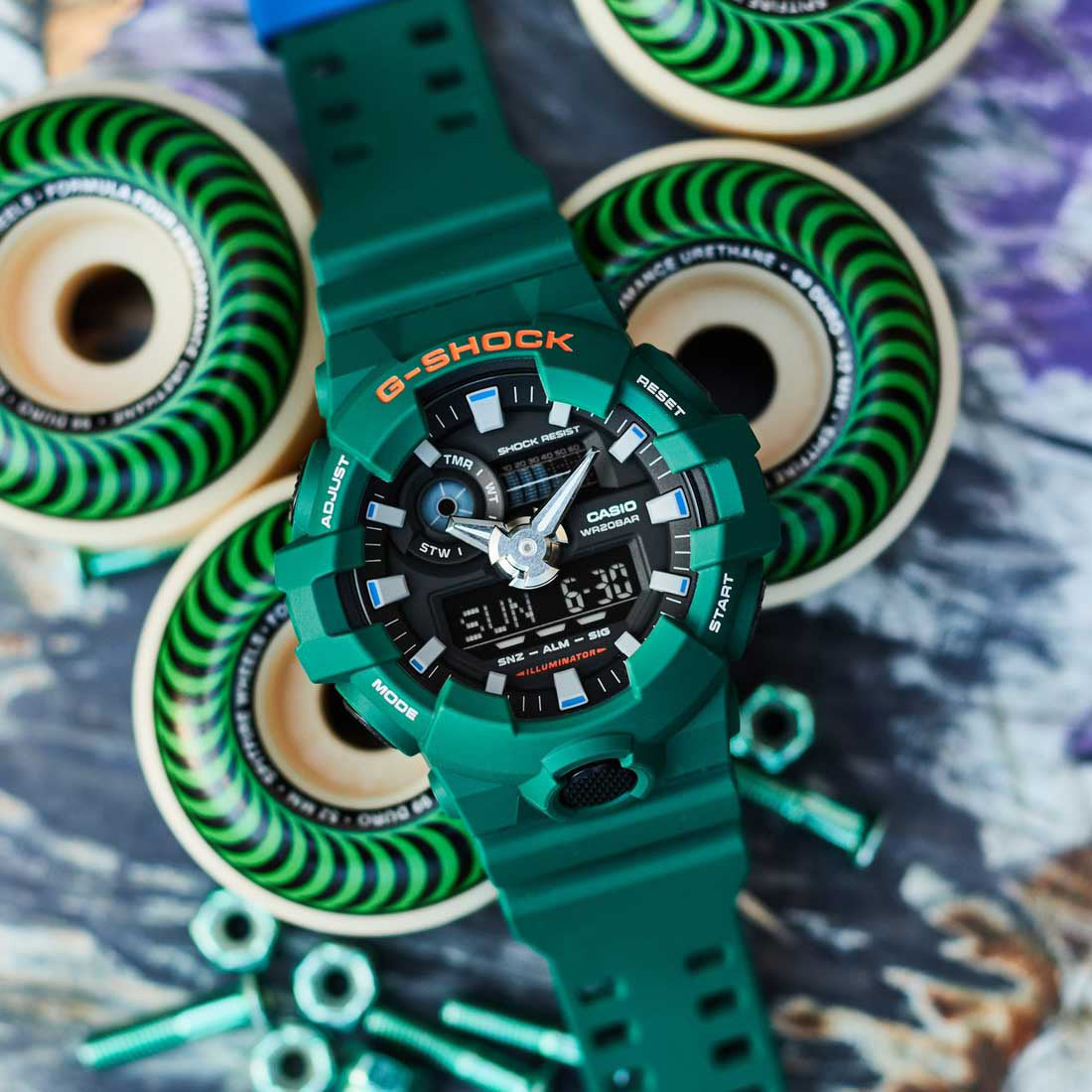 G-Shock Skater Flavour GA700SC-3A. Green watch with skateboard background.