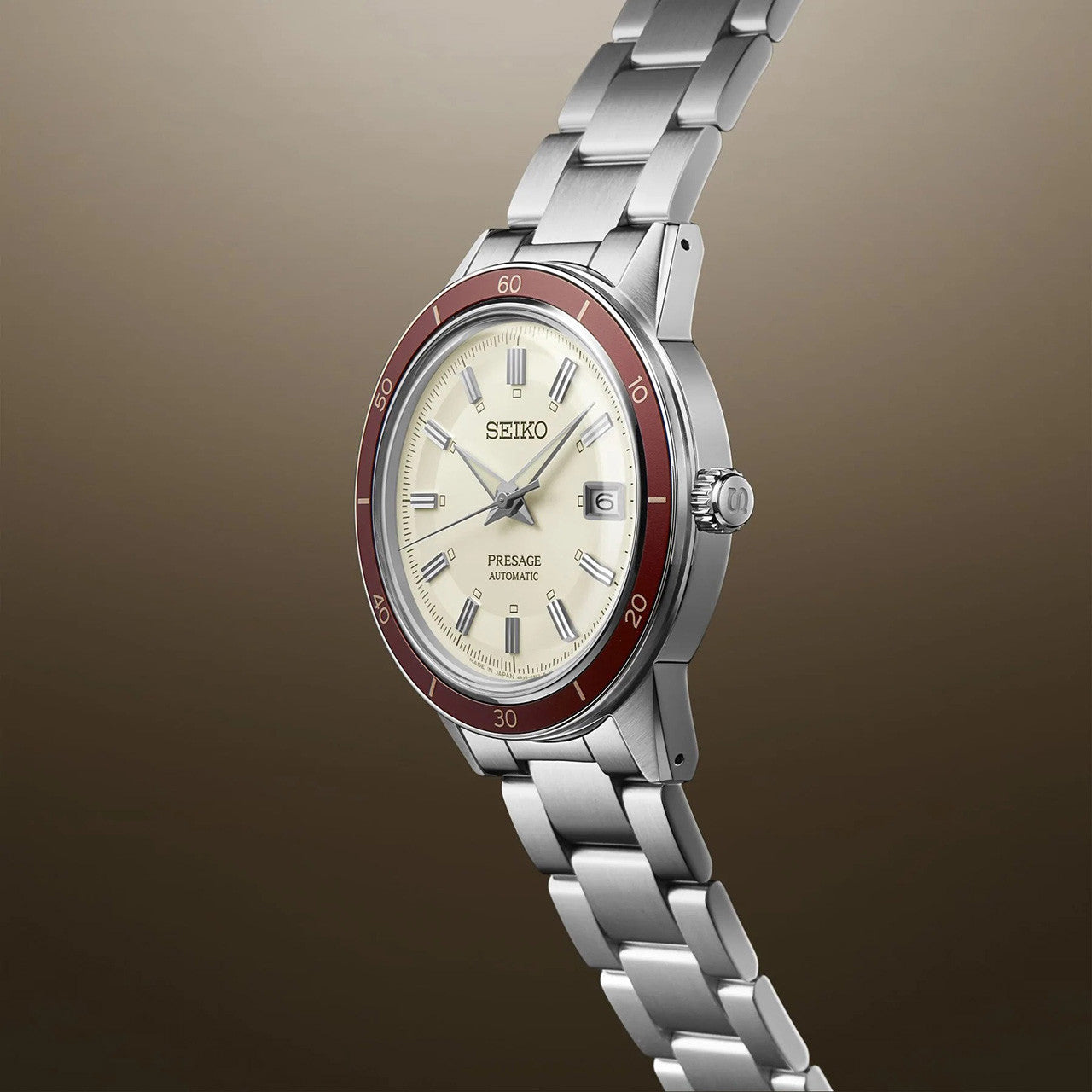 Seiko Style 60's. SRPH93J Presage maroon watch with cream dial against plain background.