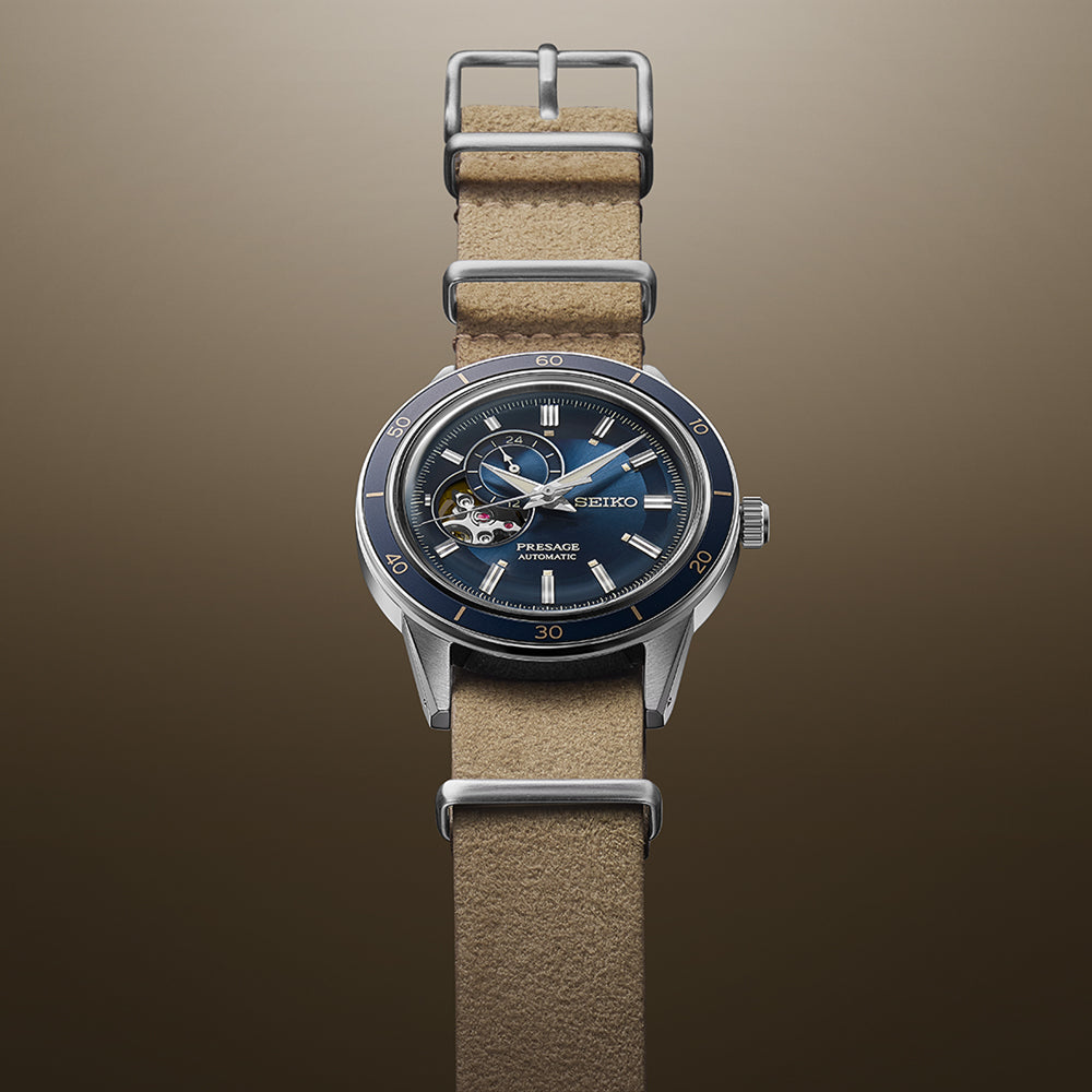 Seiko Style 60's. SSA453J Presage watch with brown strap and blue dial against brown background.