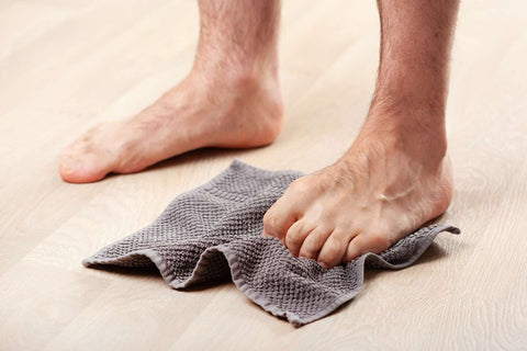 exercising feet by grabbing towel