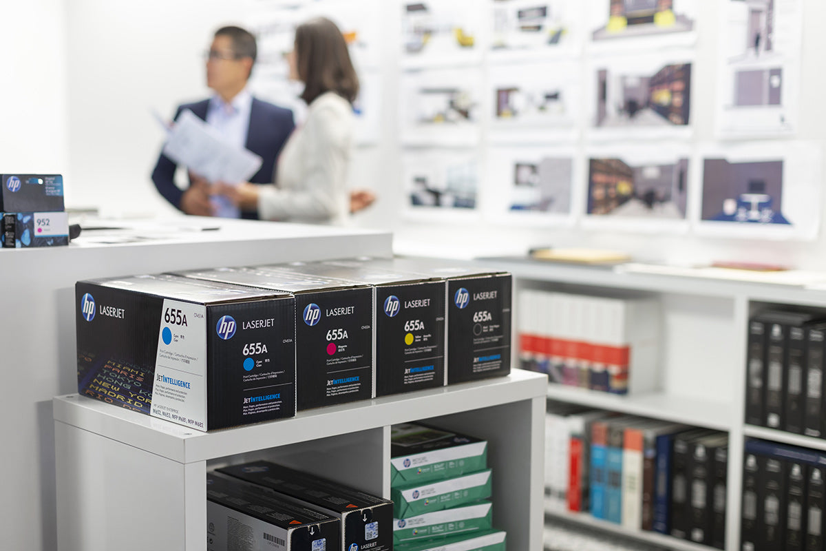 HP inks on a shelf in a store with people browsing in the background