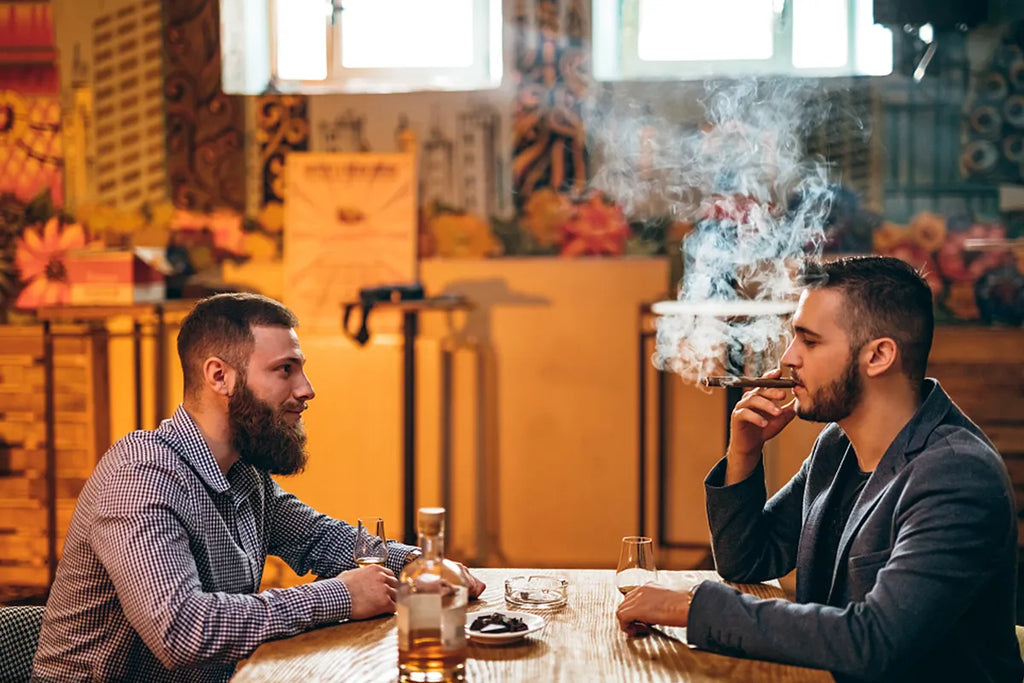 man smoking in front of another man