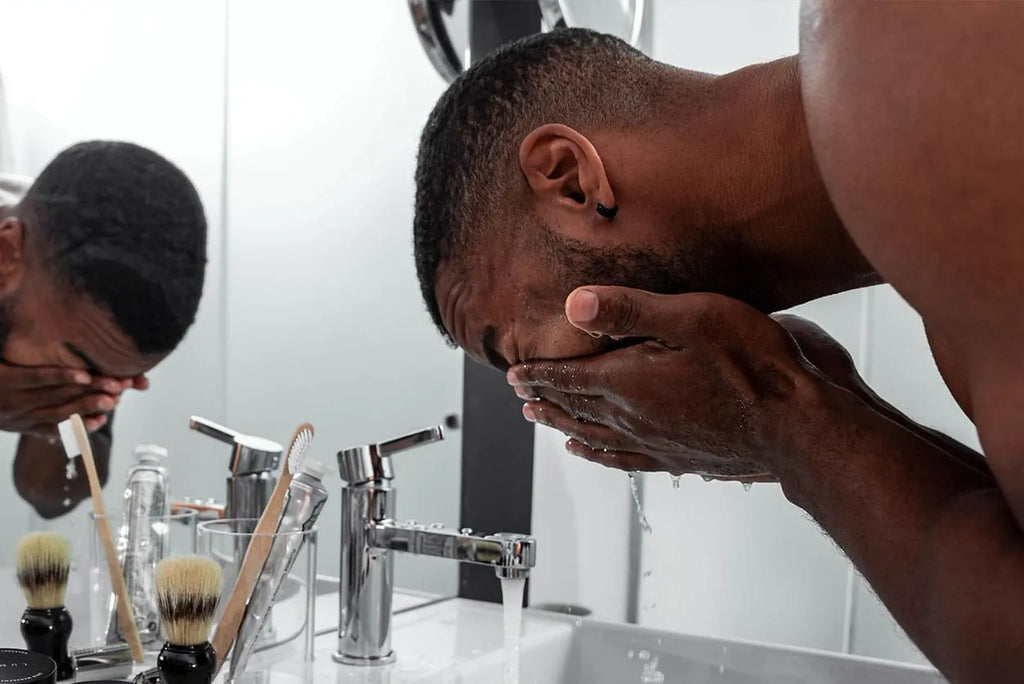 man washing face