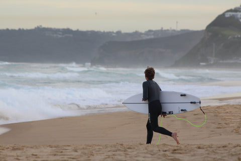 Surfer at dixon park beach australia running to catch waves