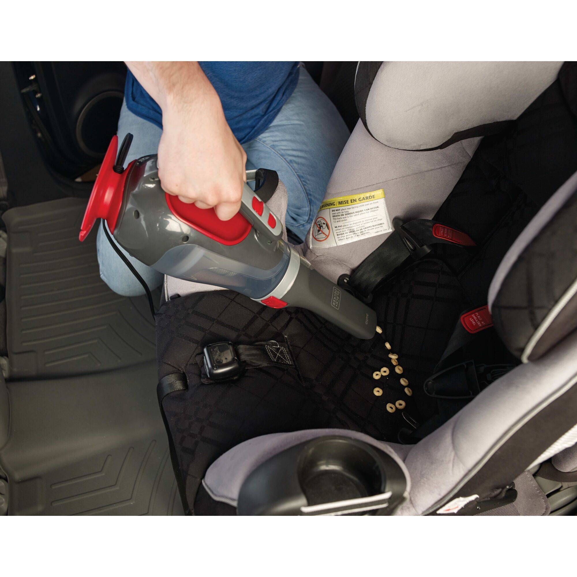 Dust buster Car Handheld Vacuum being used on car seat.