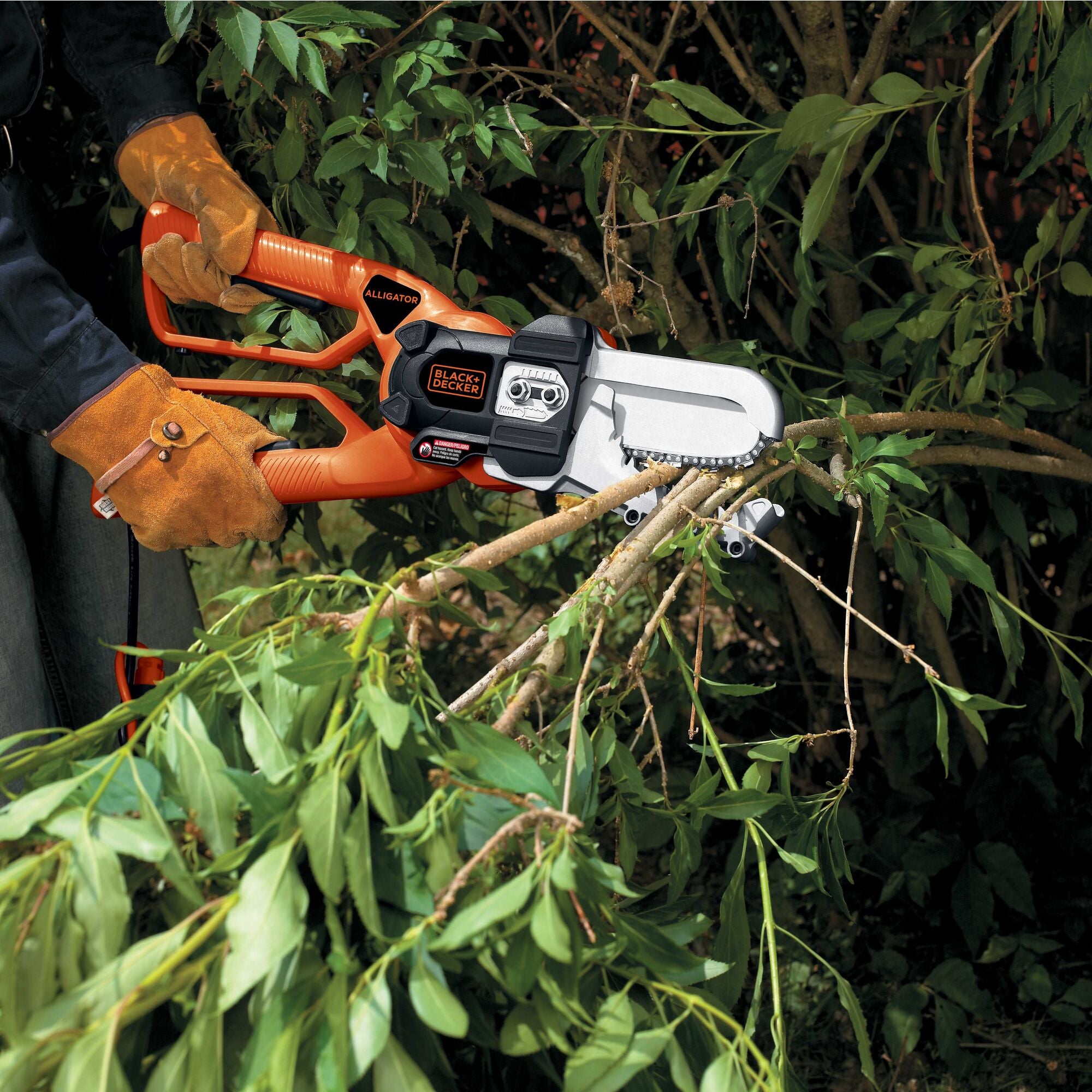 Alligator Lopper being used on branches by a person.