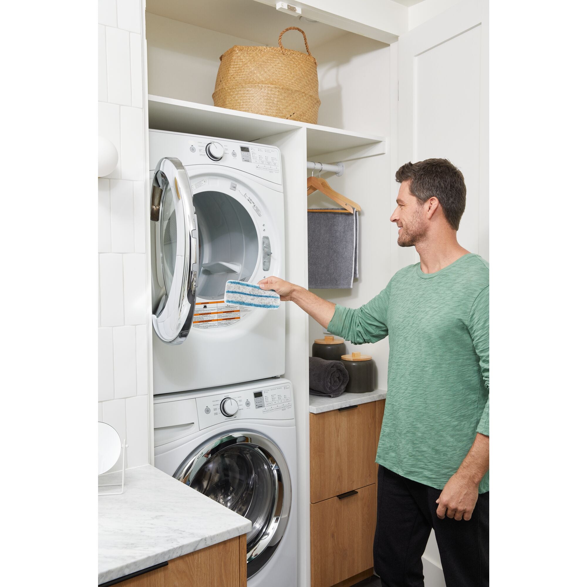 A man is cleaning oven grills using a BLACK+DECKER Multipurpose Steam Cleaning System.