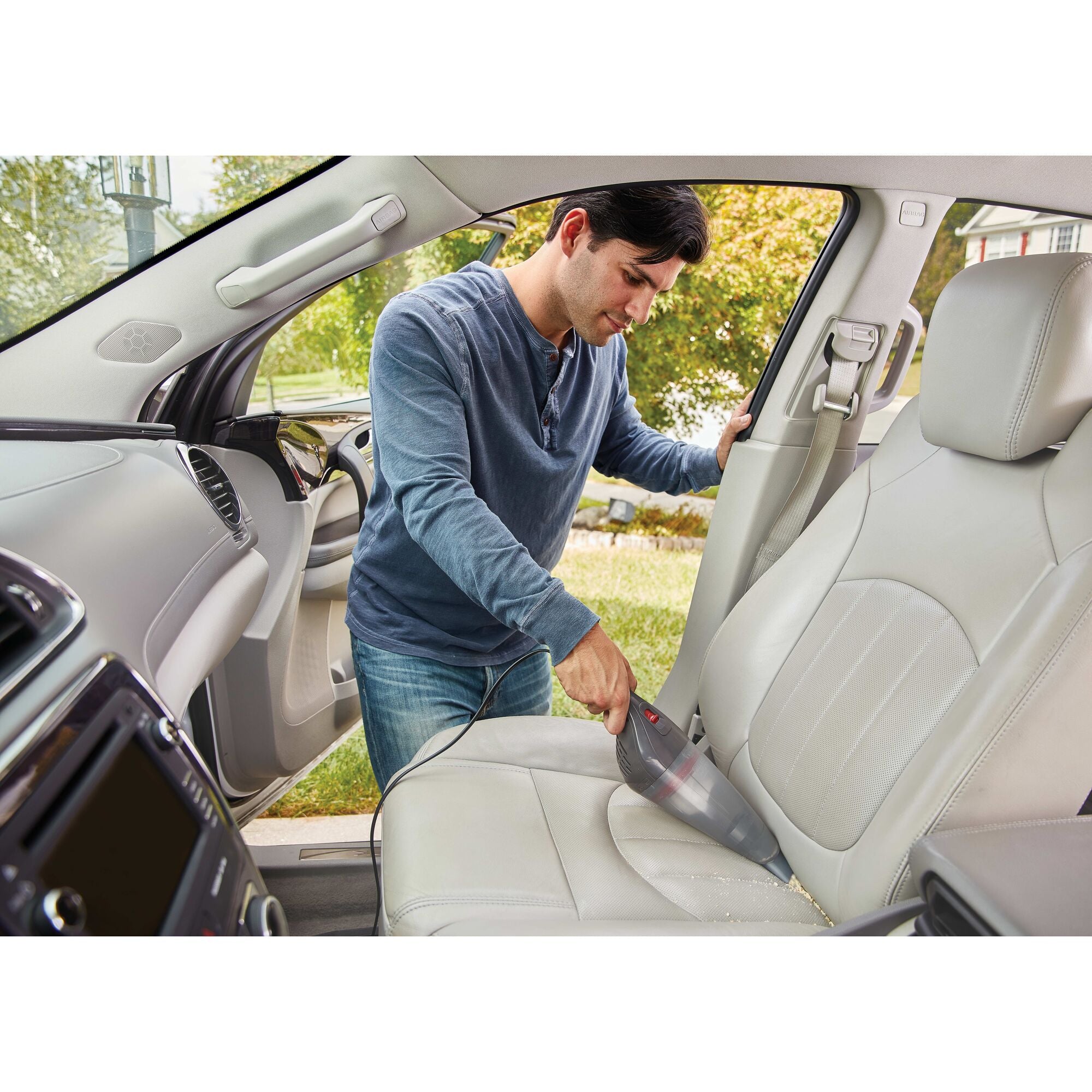 Black and decker handheld vacuum for car being used .