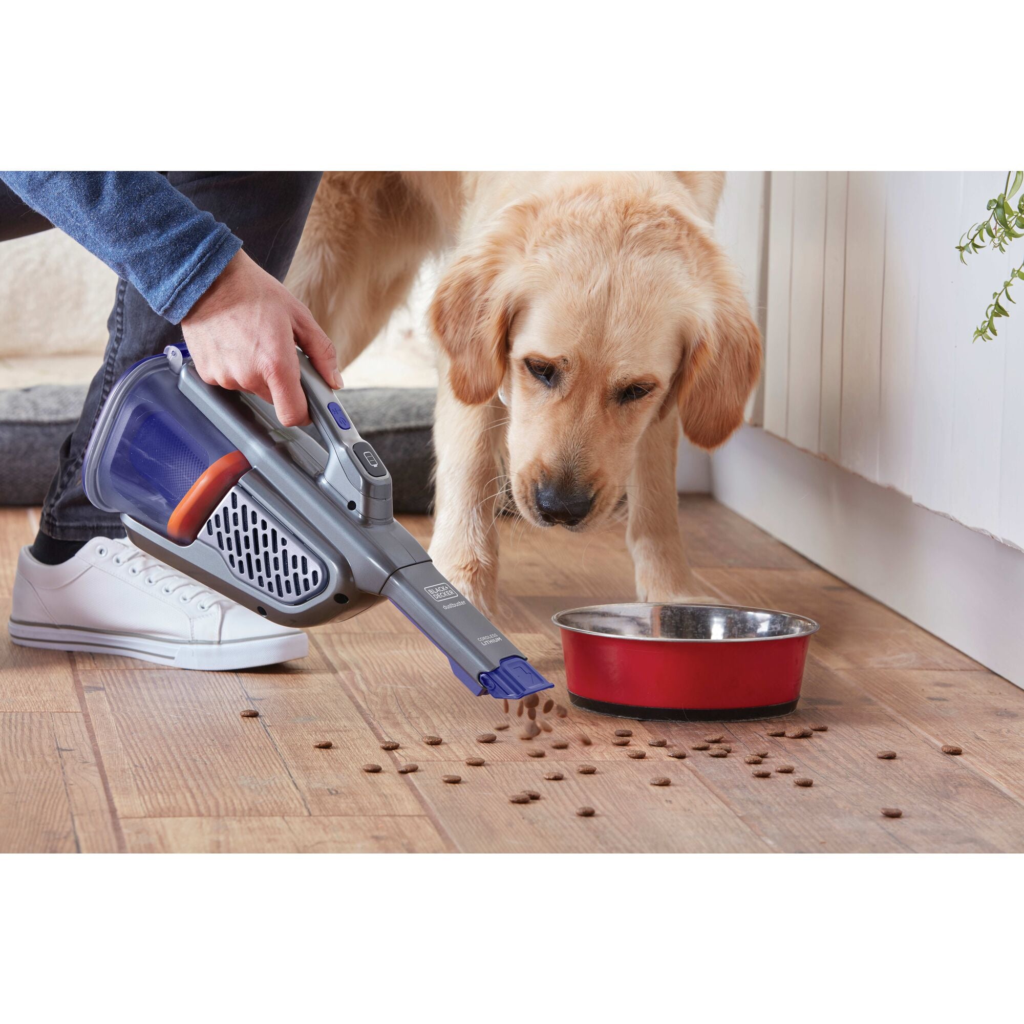 dustbuster AdvancedClean pet cordless hand vacuum being used by a person to clean stairs.