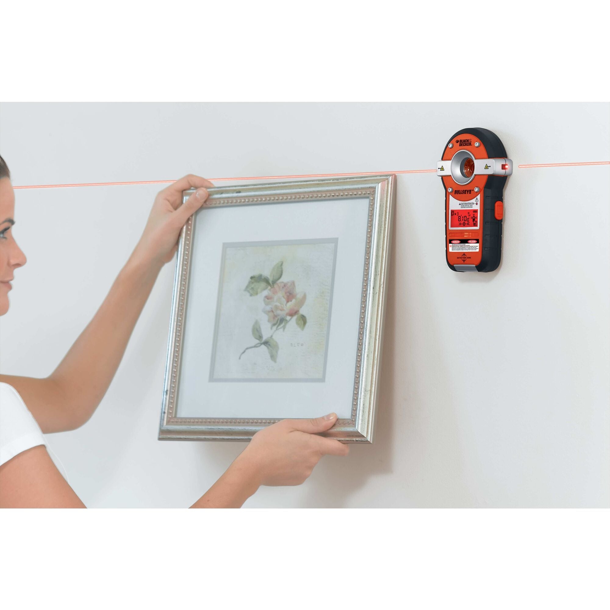 Bulls Eye Auto Leveling Laser with Stud Sensor being used for hanging mirror on wall.