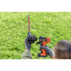 Person shows how the BLACK+DECKER MATRIX Shear-shrubber attachment slides on to the orange, 20 Volt MATRIX Power Unit.