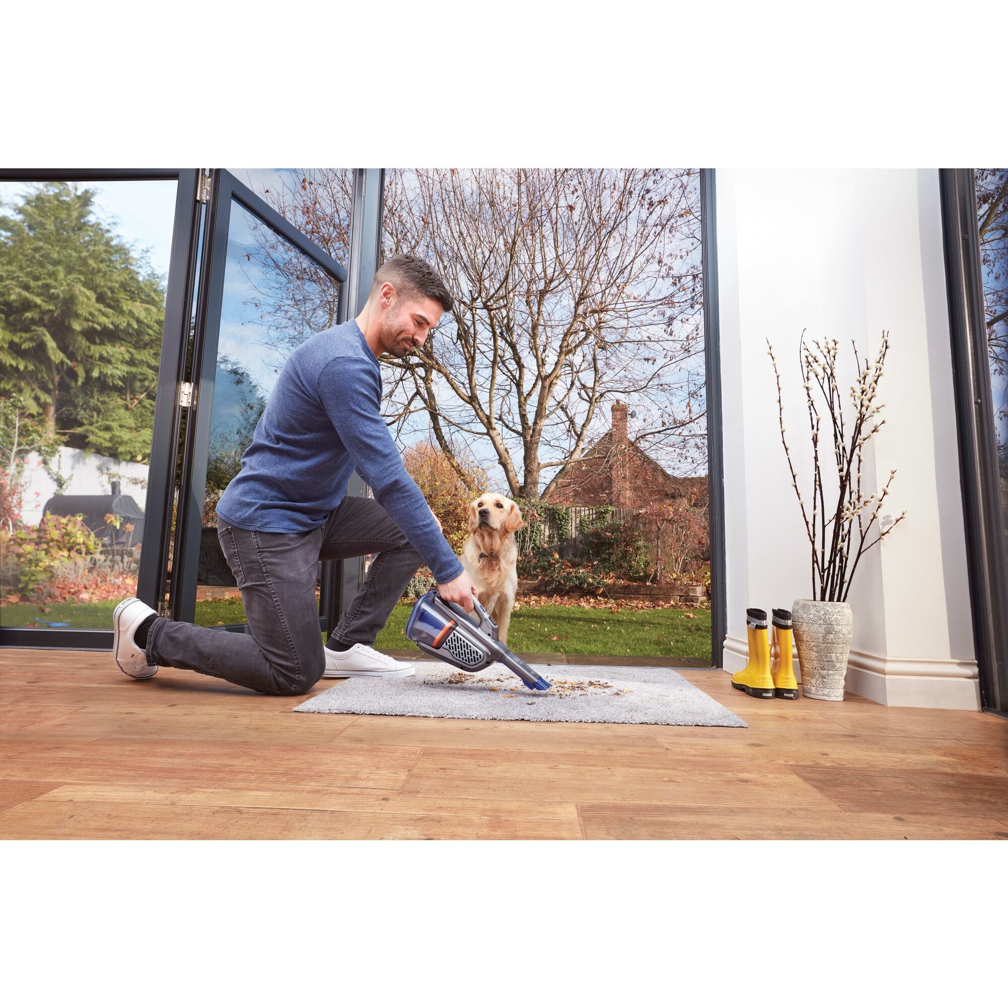 Dustbuster advanced clean pet cordless hand vacuum being used by a person.