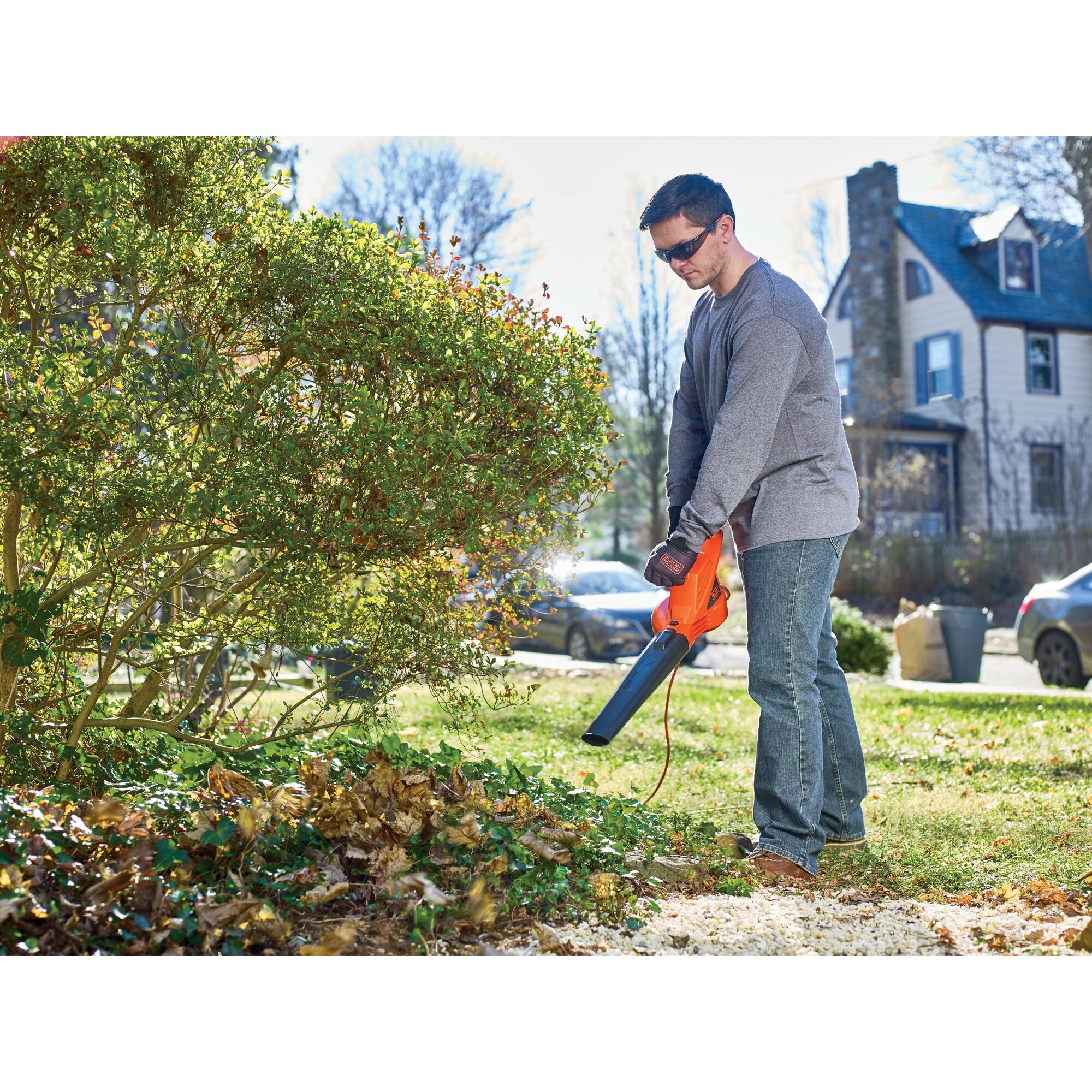 7 Amp blower being used by a person to clean yard.