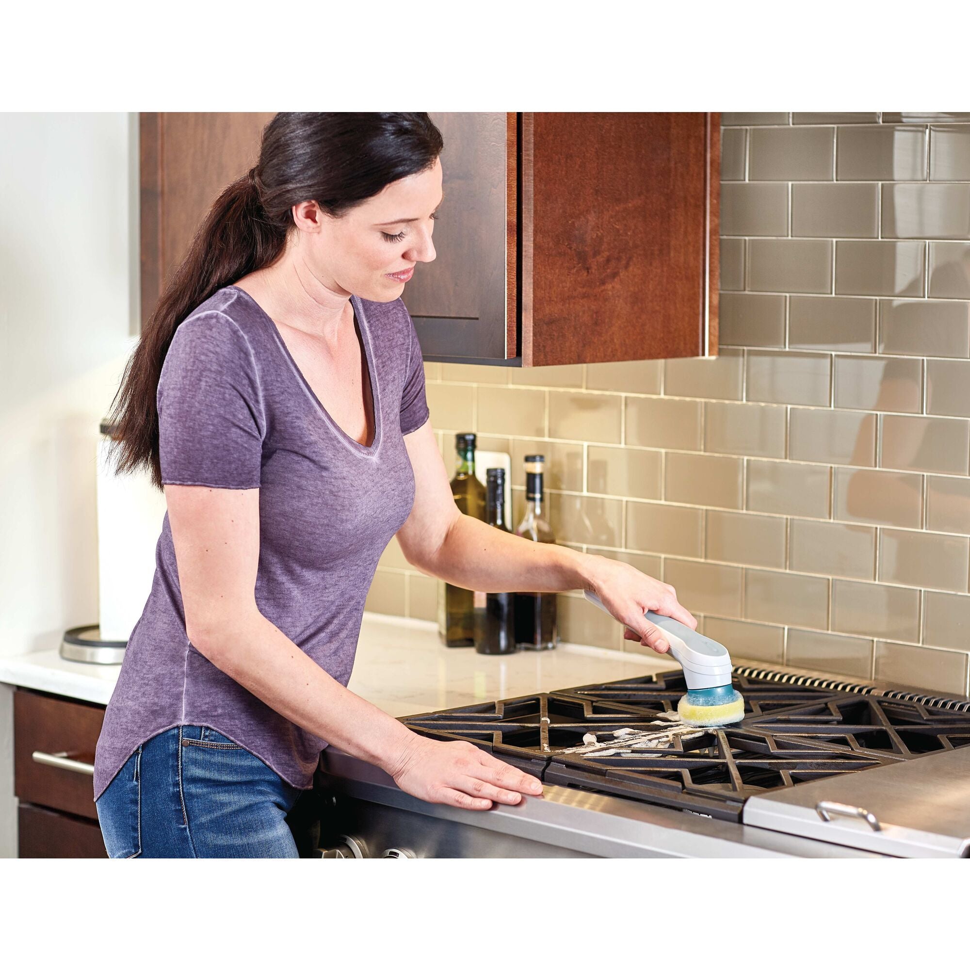 Grimebuster Heavy Duty Replacement Sponges being used to clean stove tops by a person.