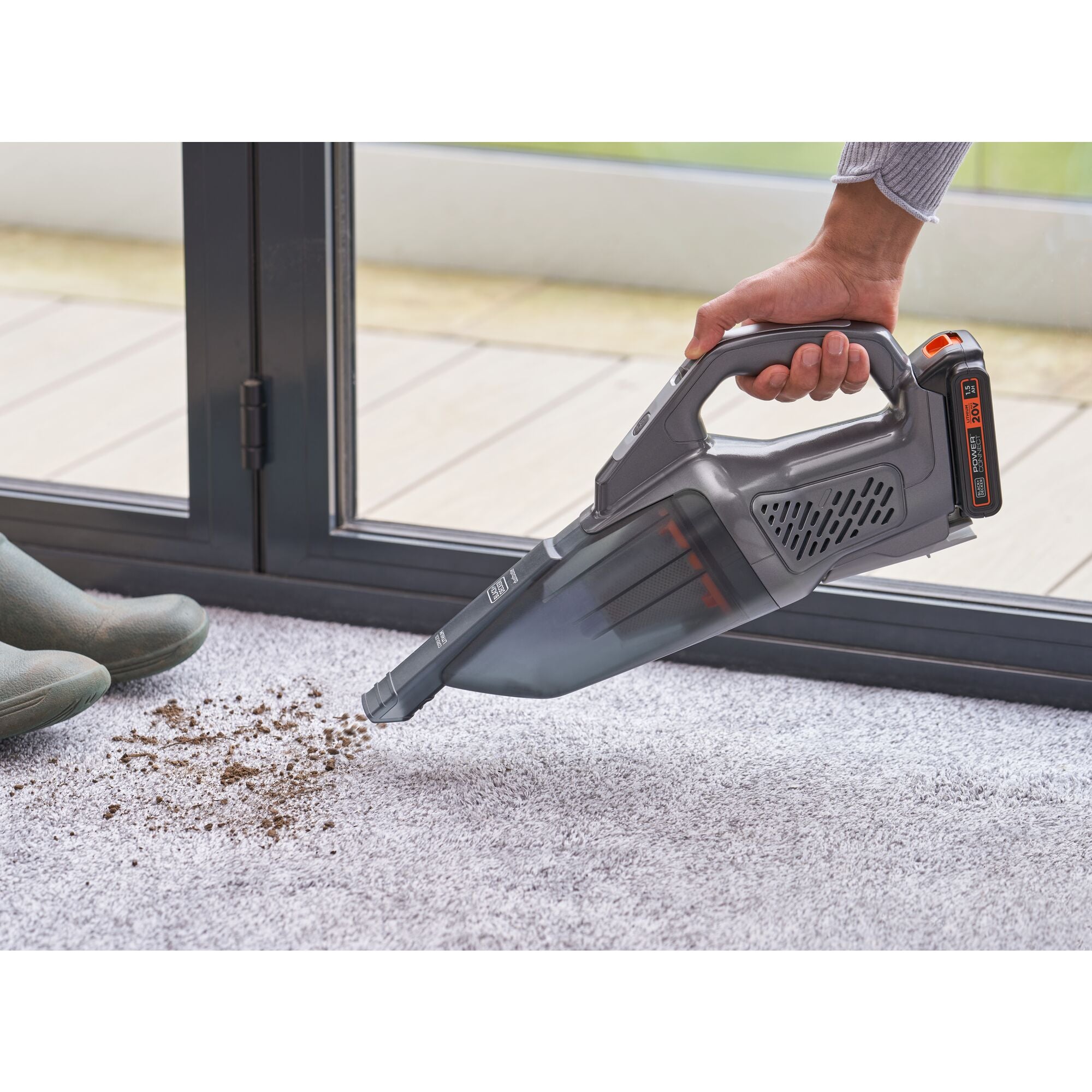BLACK+DECKER dustbuster® POWERCONNECT™ 20V MAX* Cordless Handheld Vacuum cleaning the spilled soil from the floor.