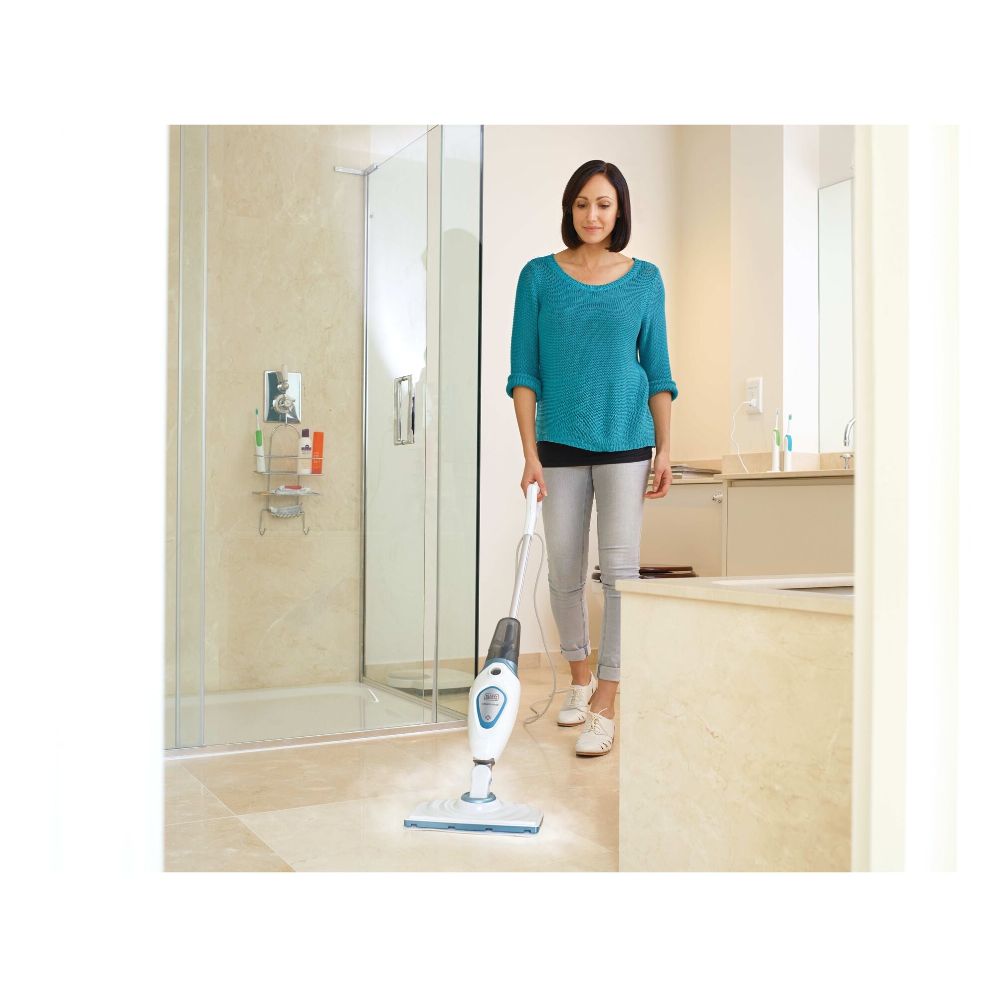 Steam mop with lift plus reach head being used to mop the bathroom floor by a person.