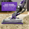 A person cleans a rug with the BLACK+DECKER POWERSERIES™ Cordless Pro Pet Stick Vacuum Cleaner. Anti-tangle rubber bristles. Tackle tough pet hair with ease.