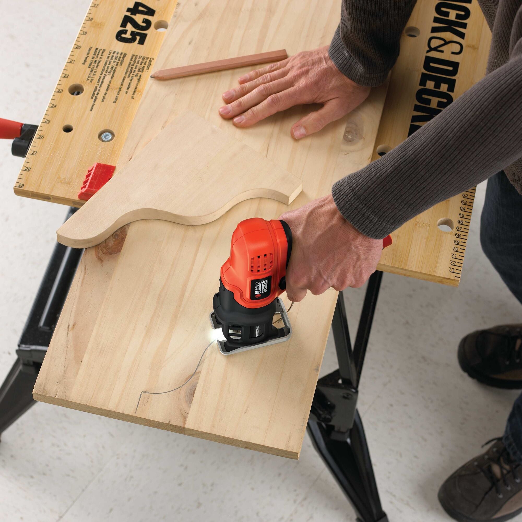 Compact saw with lithium ion battery being used to cut P V C.