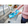 A woman is cleaning the trash holder of the BLACK+DECKER spillbuster™ Cordless Spill + Spot Cleaner.