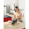 Dustbuster pivot vac cordless hand vacuum being used by a person.