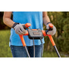 A person is holding the handles of the BLACK+DECKER Electric Lawn Mower.