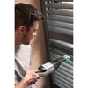 Man cleaning blinds with the BLACK+DECKER reviva hand vac