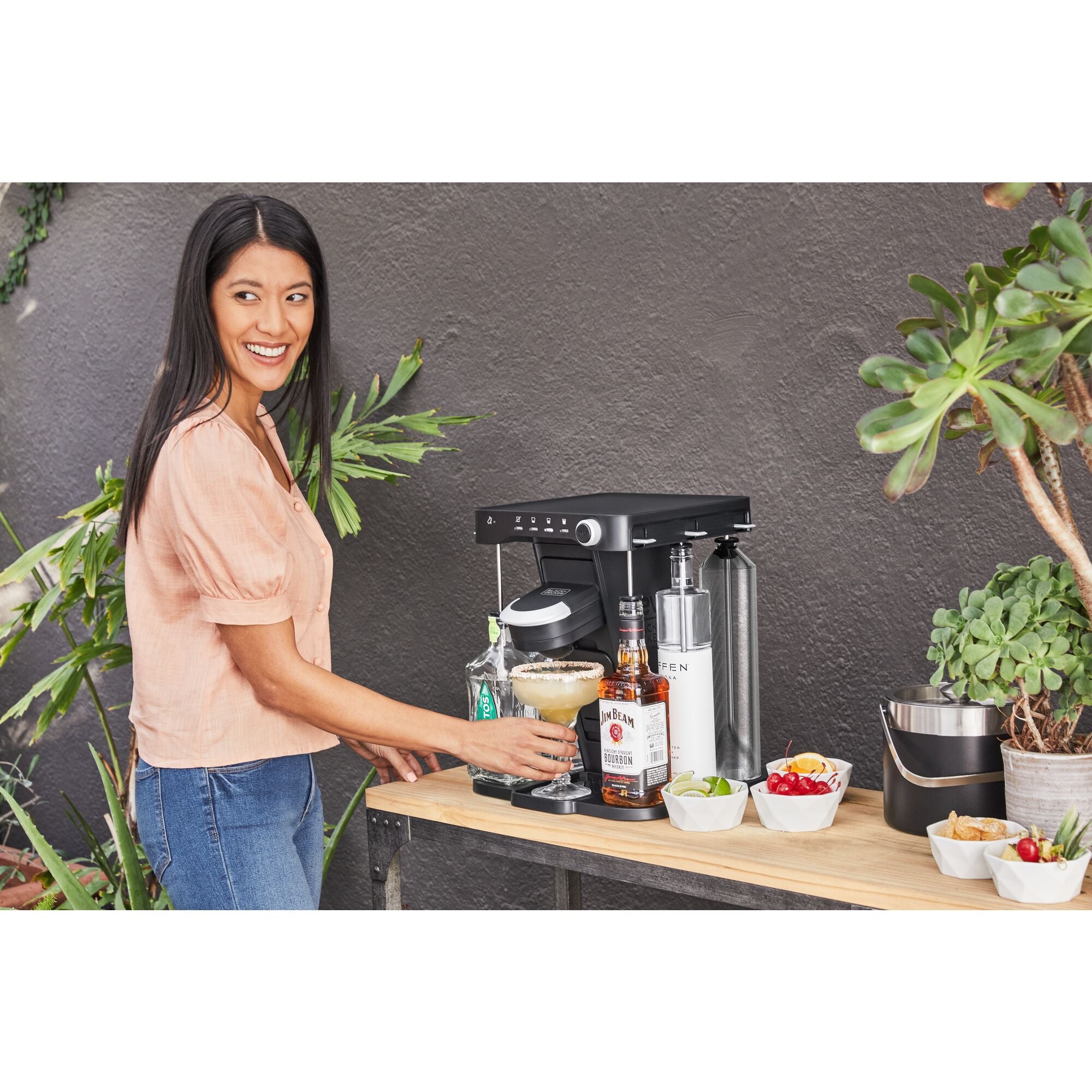 close-up of the bev by BLACK+DECKER™ cocktail maker on a gold bar cart in a living room