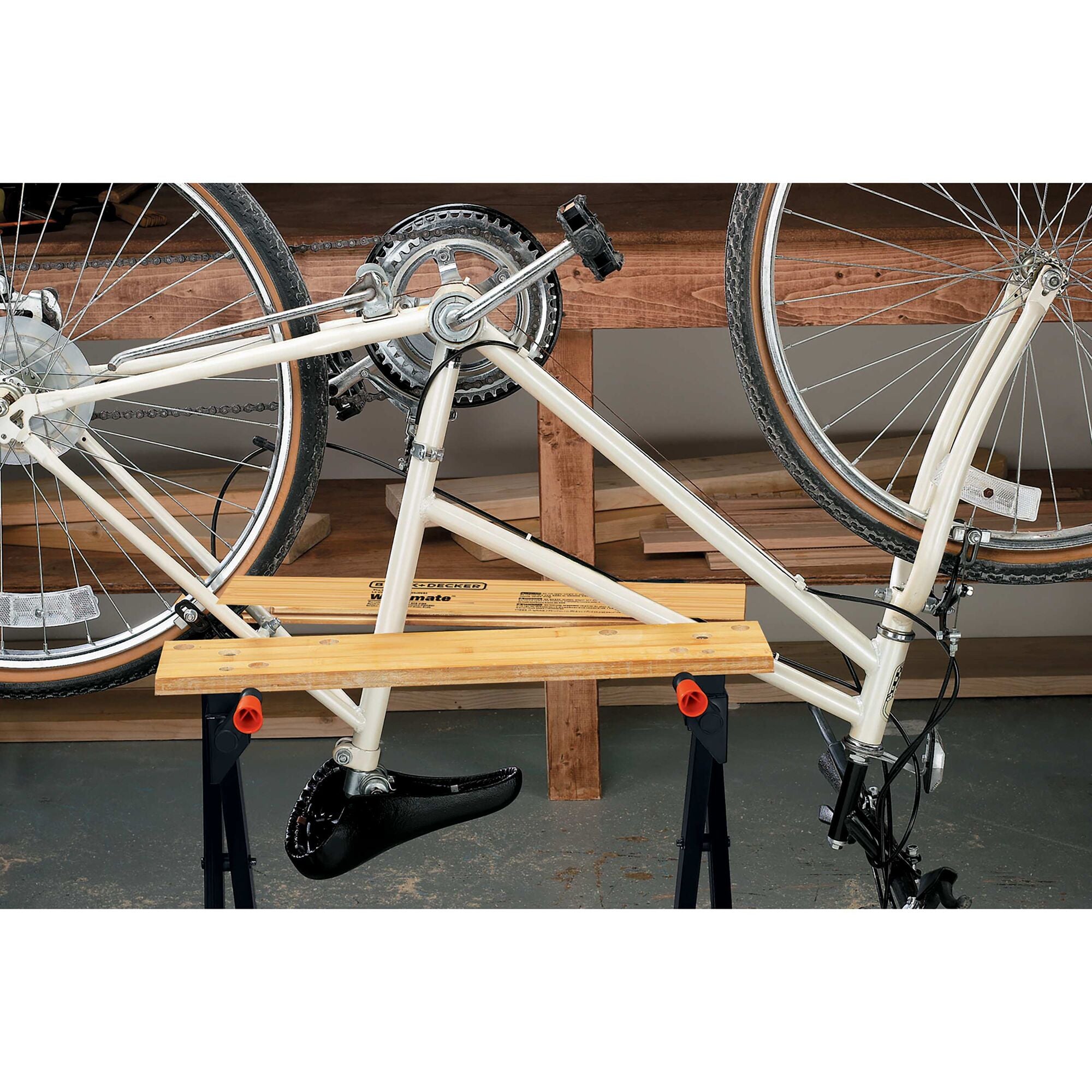 A bike secured by the BLACK+DECKER Workmate™ Portable Workbench With 350-Pound Capacity. Heavy-duty steel fram plus warp-resistant wooden vise jaws.