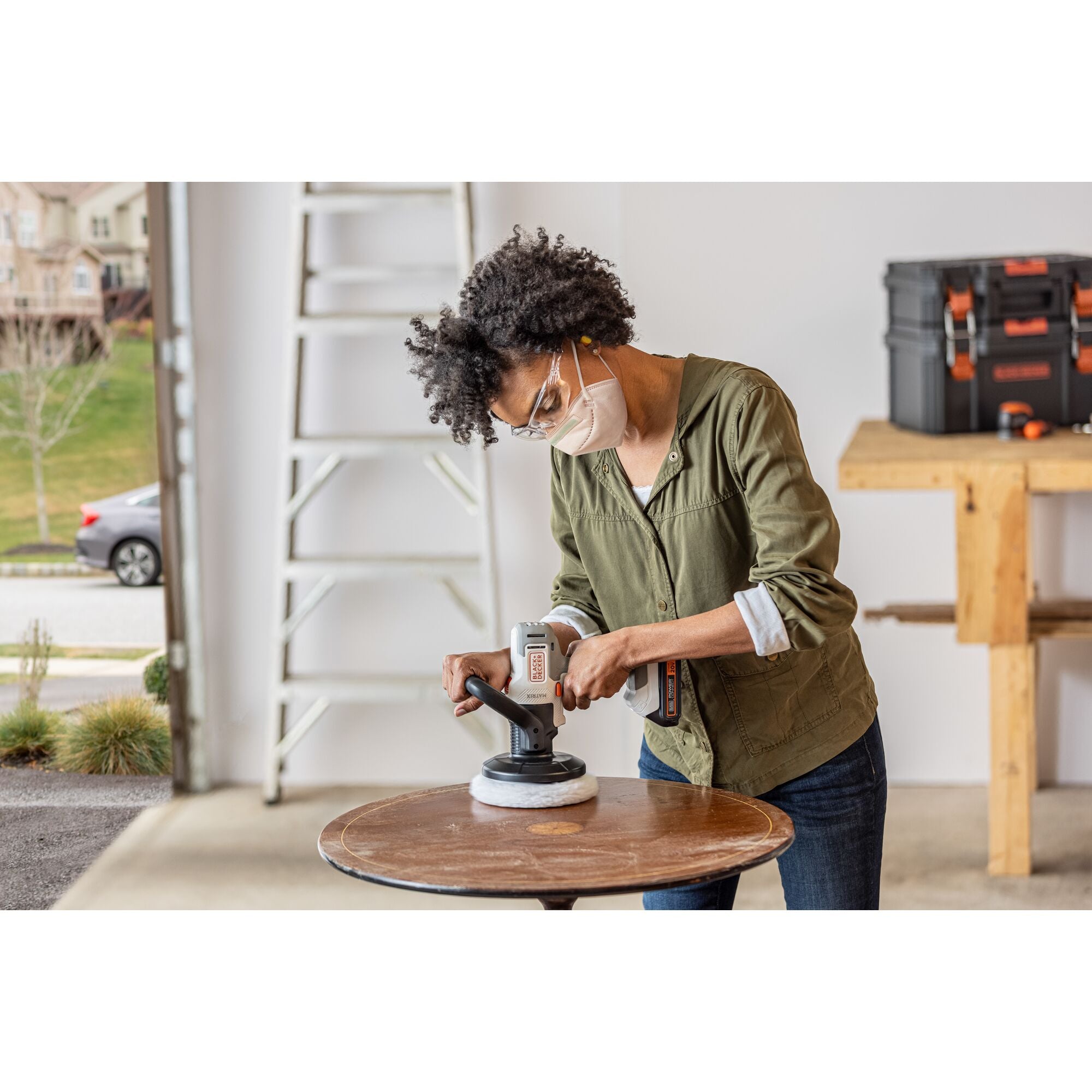 Person polishes table with the BLACK+DECKER MATRIX Buffer attachment.