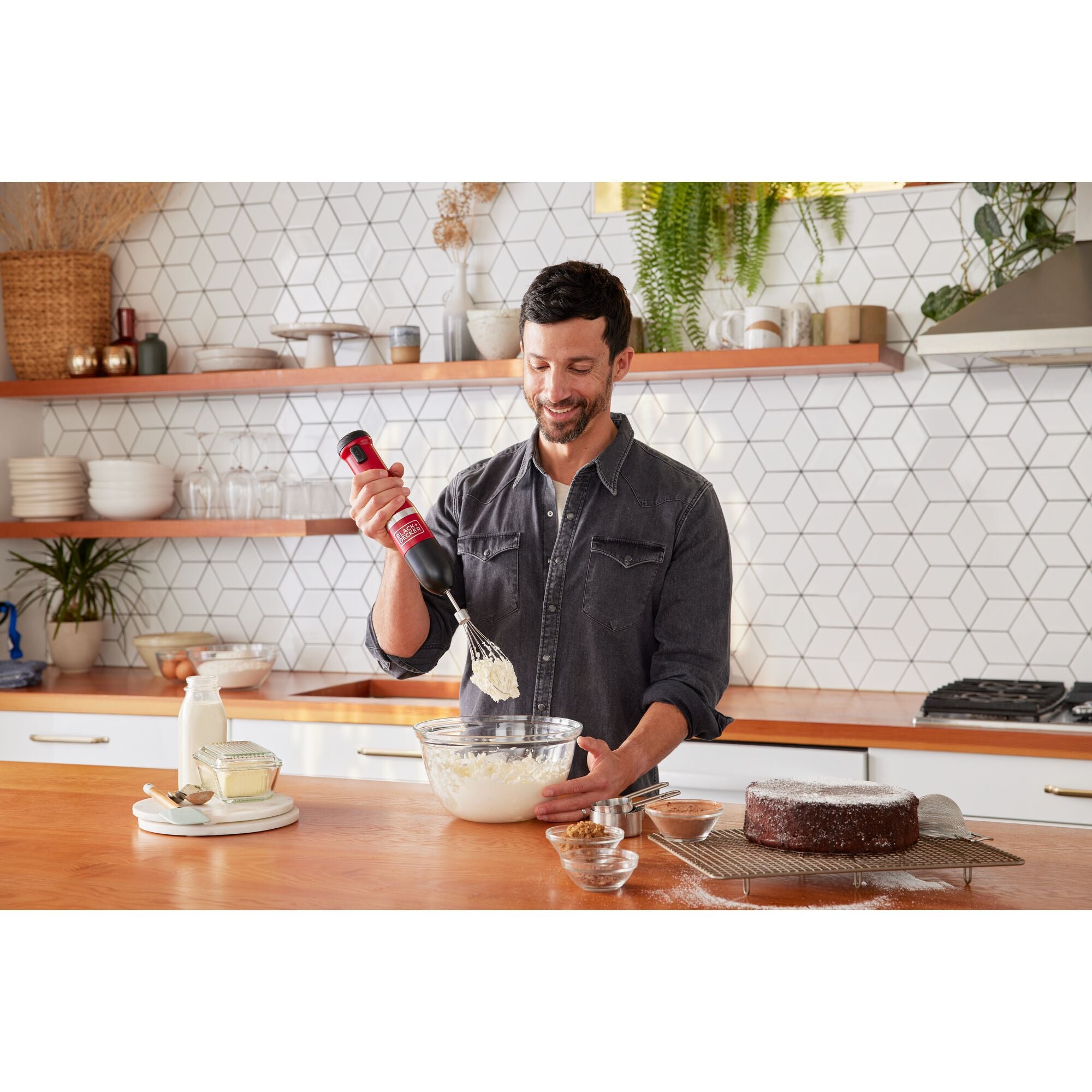 Talent using the red, BLACK+DECKER kitchen wand can opener to open canned tomatoes