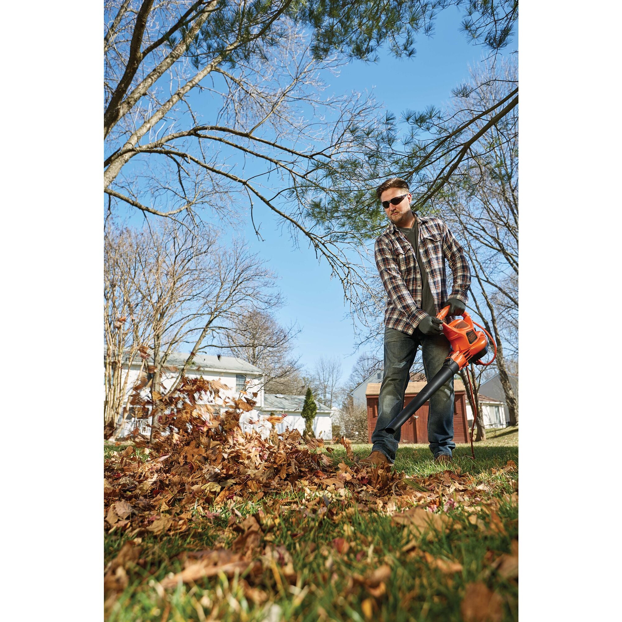 3 in 1 VAC PACK 12 Amp leaf blower, vacuum, and mulcher being used by a person to pick up leaves in yard.