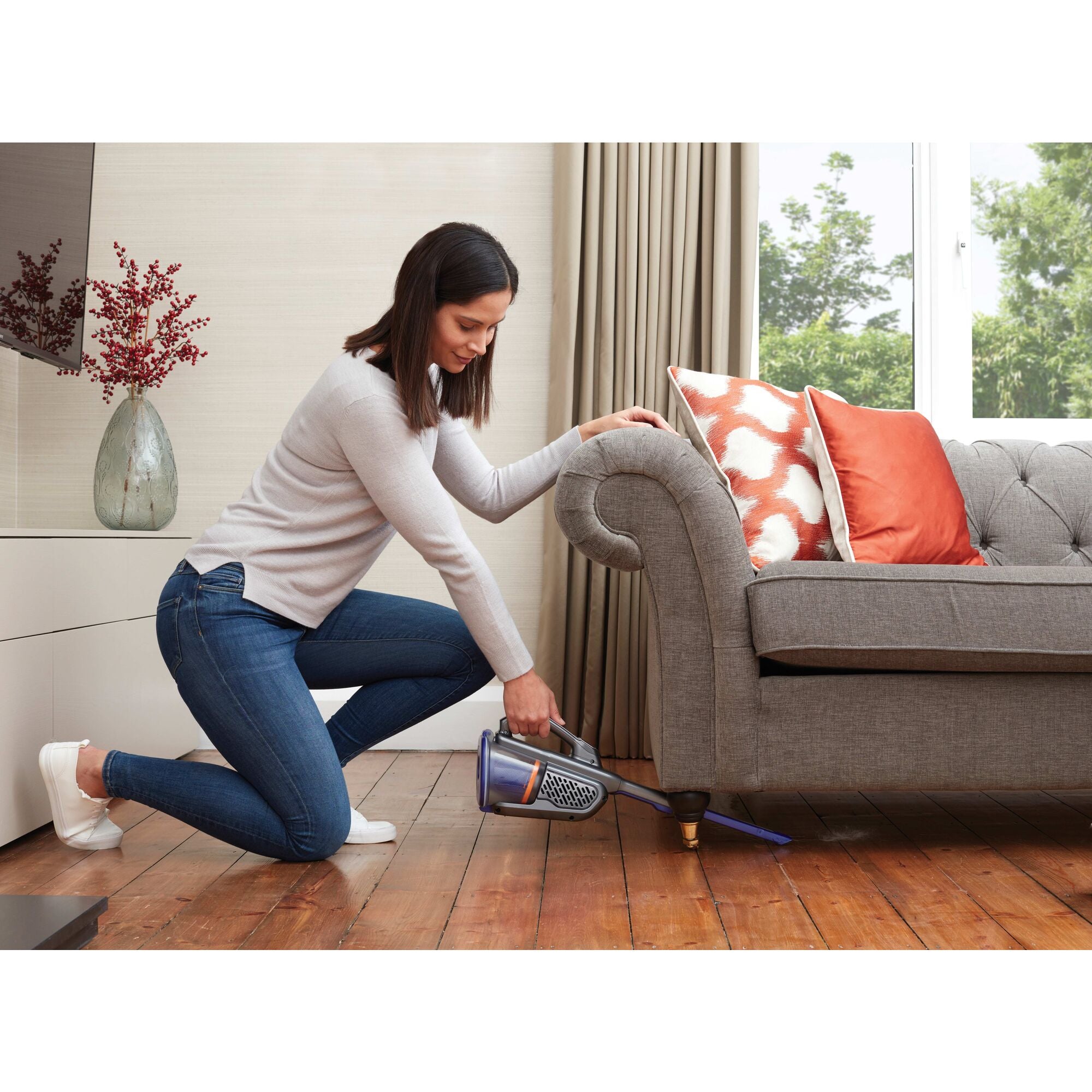 Advanced Clean plus Pet Hand Vacuum being used by person to clean pet fur from couch.